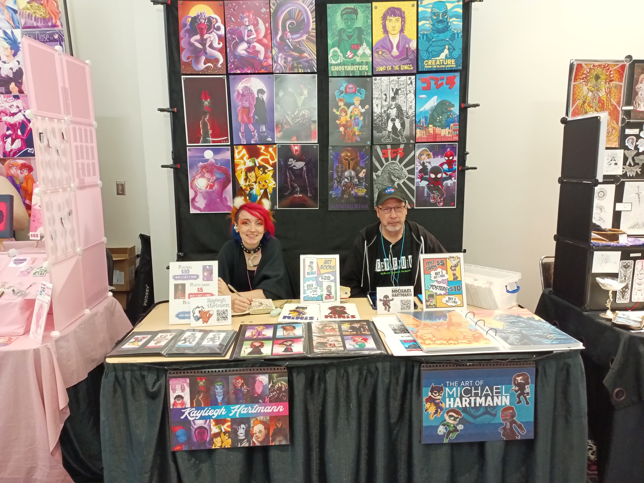 Handmade creative works on display at a convention table.